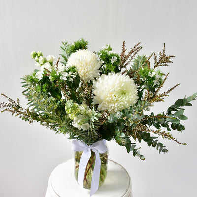 A pretty posy of seasonal blooms, in a mason jar tied with a bow.  Includes what's best at the market so may not be as pictured below.  A great present for those with a new baby or for minimal contact during these tricky times. They are perfect for places where vases may not be available (hospitals, aged care, new homes, or when buying the day before or transporting over a long distance, where keeping them in water is preferable.   Arrangements can be made up to $75. 